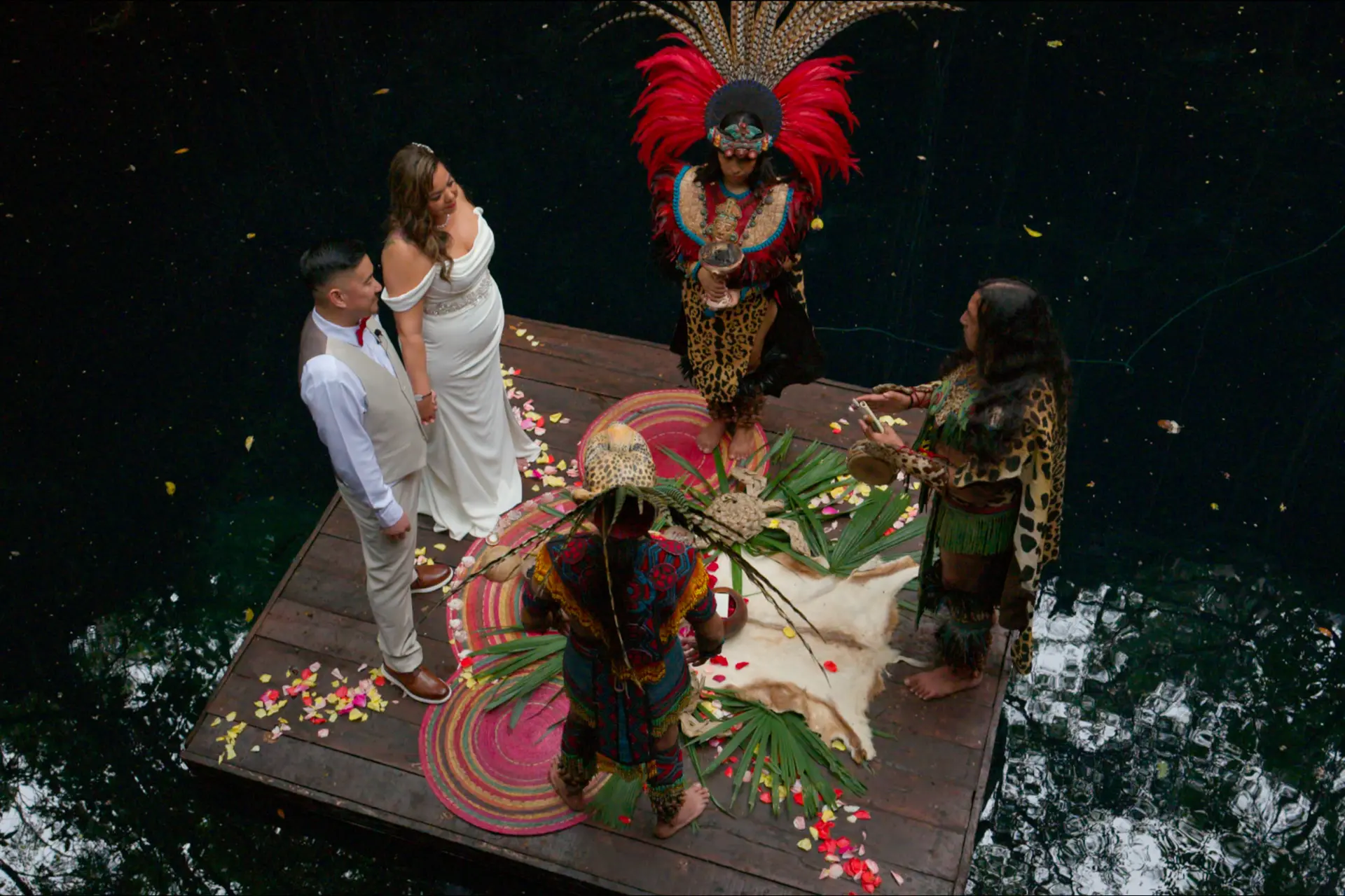 Maura and Jason during a traditional Mayan ceremony on a wooden platform over Cenote Hats'uts.